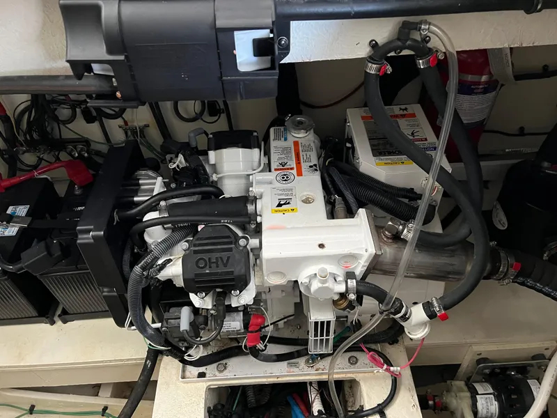 Slide: The Image of Engine compartment of 2018 Sea Ray Sundancer 350 Coupe with visible components and wiring. - 15