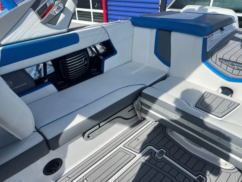 Slide: The Image of 2020 Nautique G23 boat interior with blue and white seating and modern design. - 13