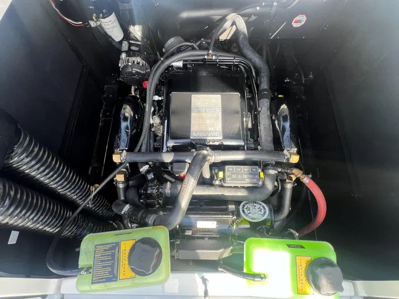 Slide: The Image of 2020 Nautique G23 engine compartment with visible components and hoses. - 22