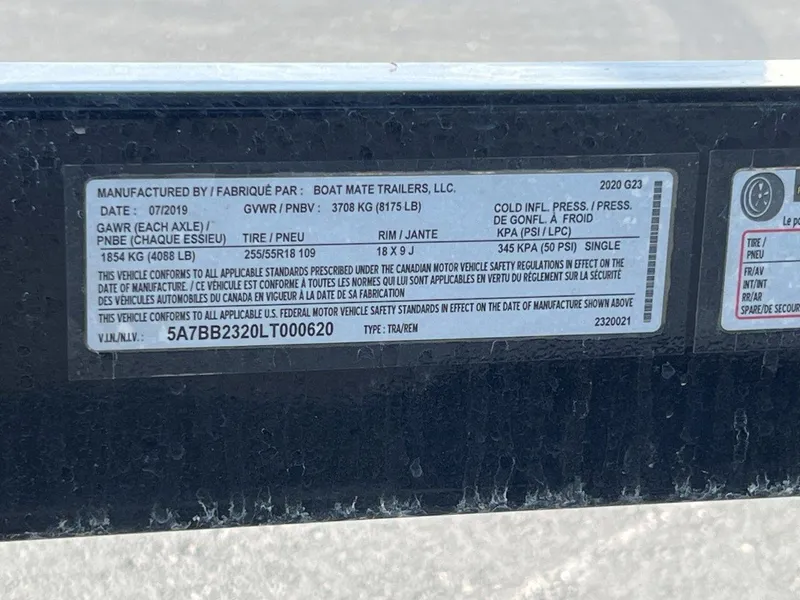 Slide: The Image of Label on a 2020 Nautique G23 trailer, detailing specifications and compliance information. - 23