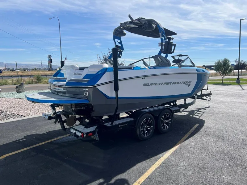 Slide: The Image of 2020 Nautique G23 boat on trailer, parked outdoors under clear sky. - 7