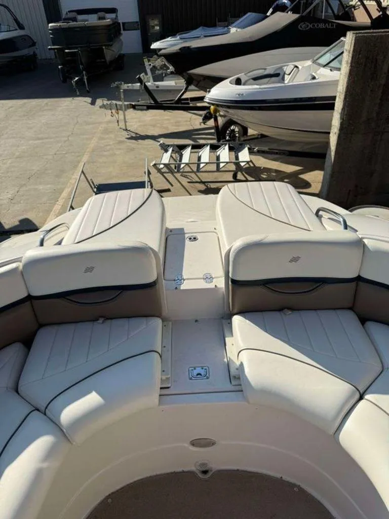Slide: The Image of 2004 Four Winns 230 Horizon boat interior with white seating in a marina. - 4
