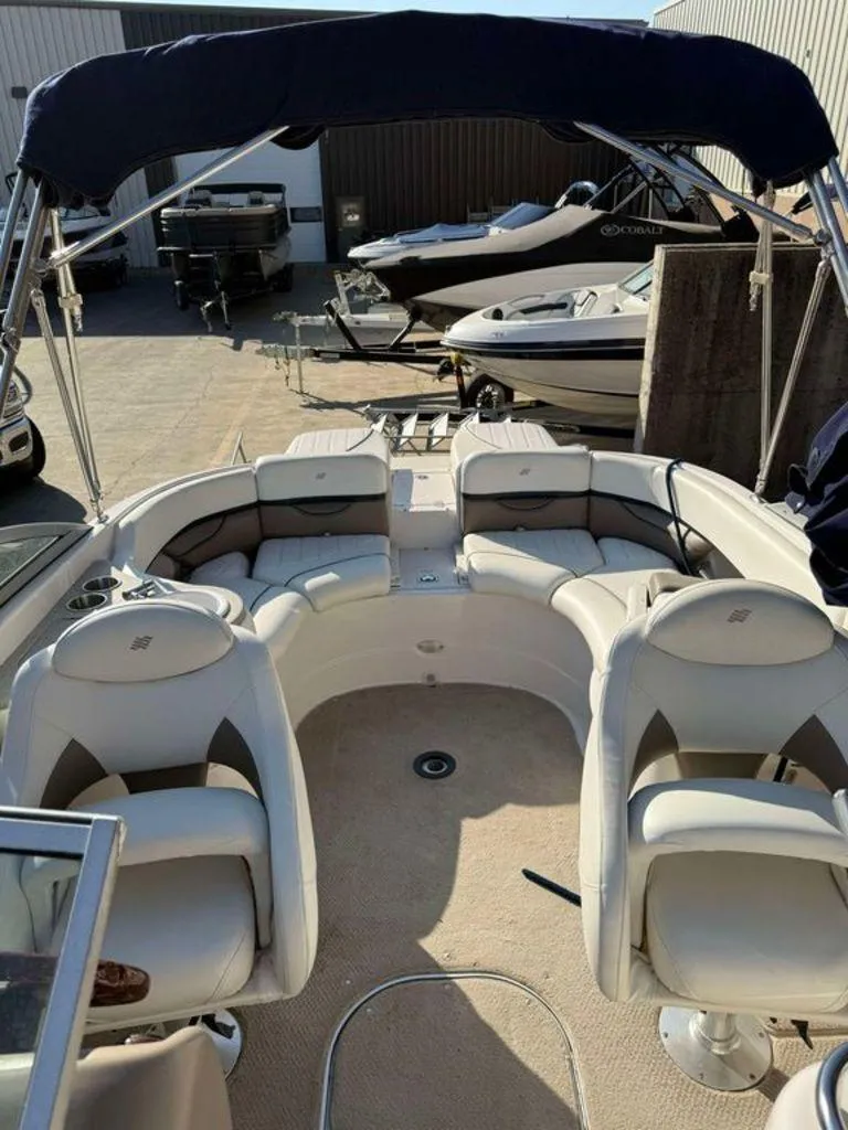 Slide: The Image of 2004 Four Winns 230 Horizon boat interior with white seating and canopy. - 6