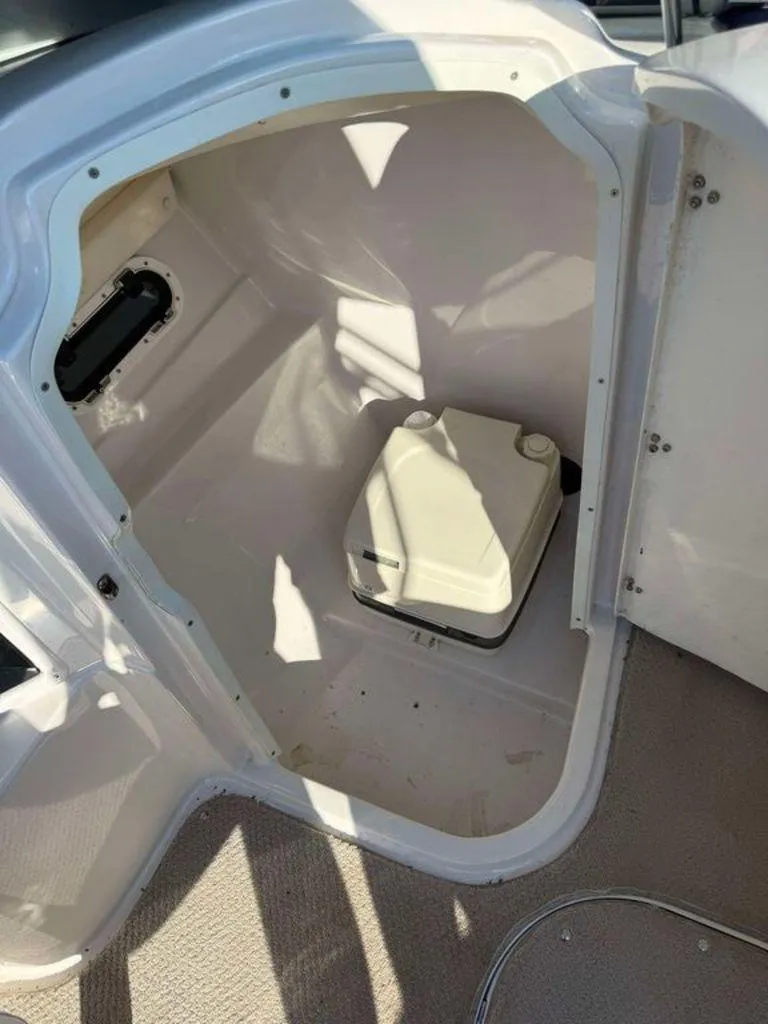 Slide: The Image of 2004 Four Winns 230 Horizon boat interior with portable toilet. - 7
