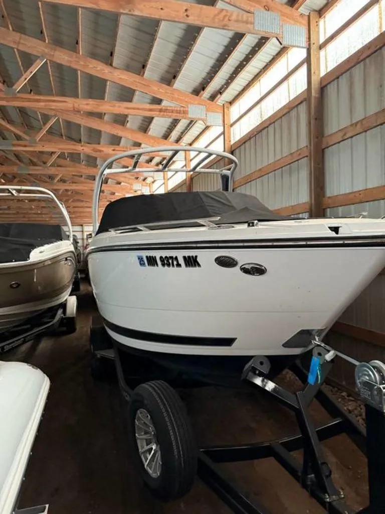 Slide: The Image of 2016 Sea Ray SLX 250 boat stored indoors on a trailer. - 0