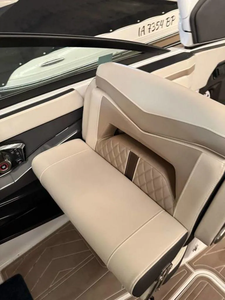 Slide: The Image of Luxurious interior seating of a 2016 Sea Ray SLX 250 boat, featuring elegant beige upholstery. - 10