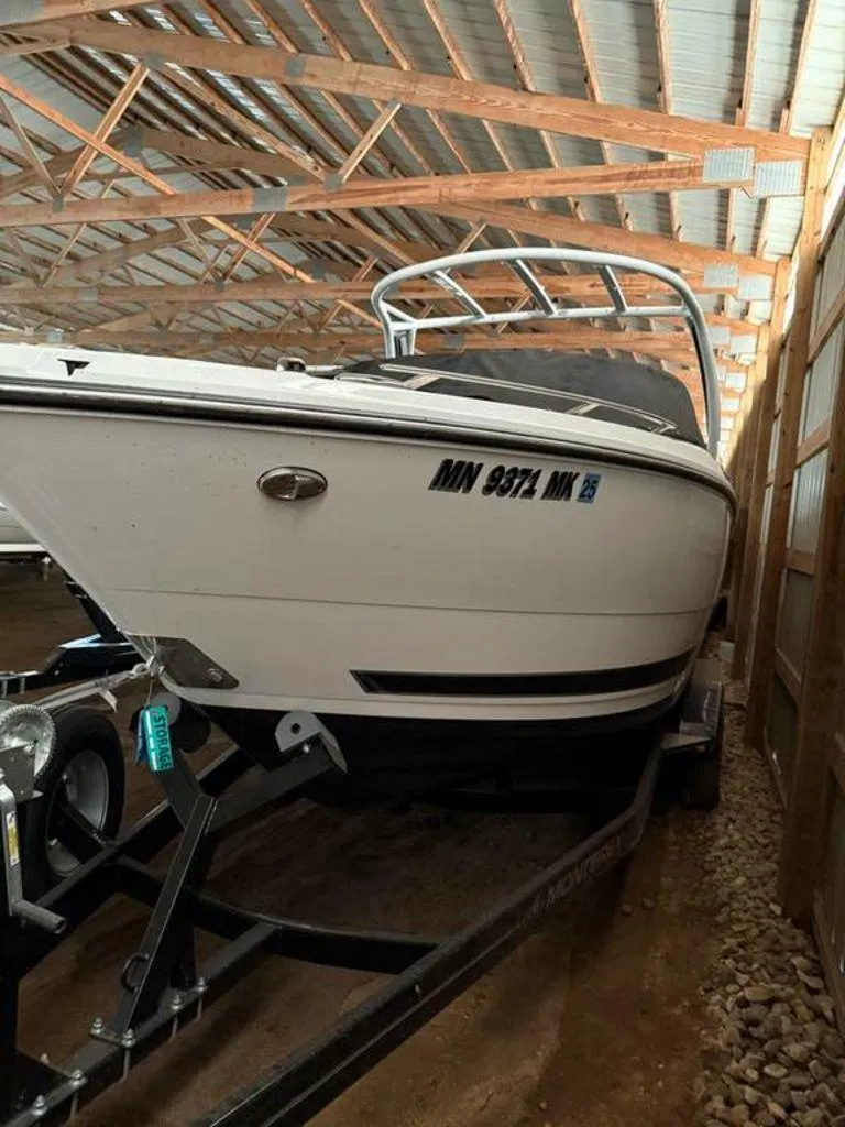 Slide: The Image of 2016 Sea Ray SLX 250 boat stored in a wooden shed on a trailer. - 11