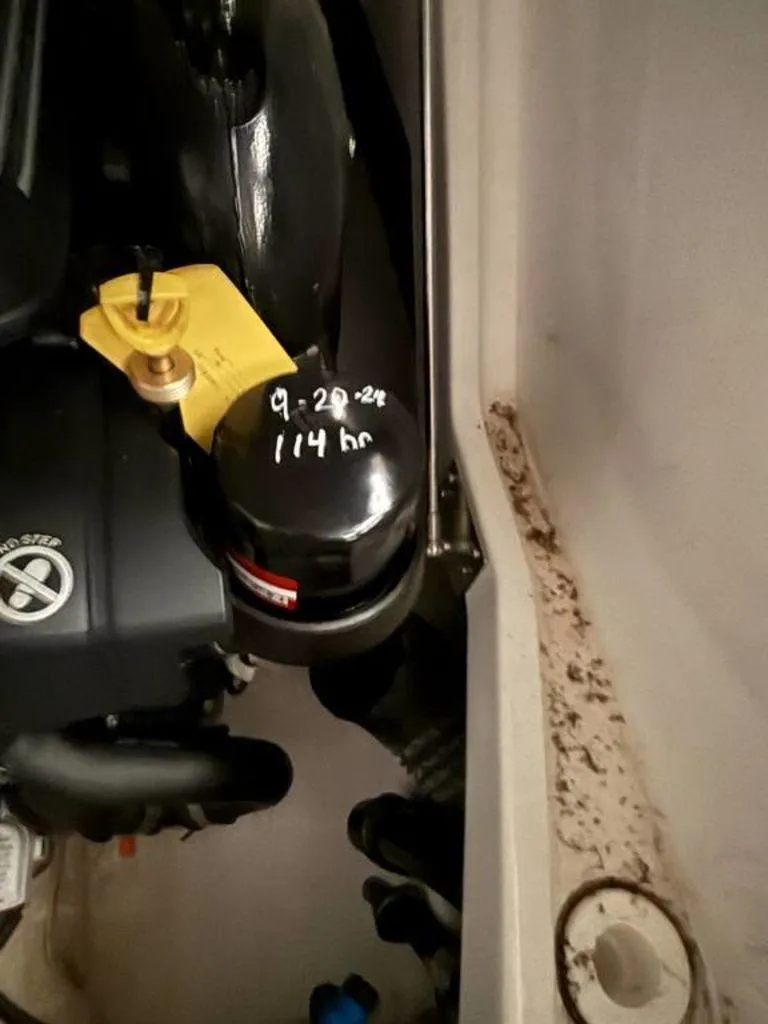 Slide: The Image of Engine compartment of 2016 Sea Ray SLX 250 with maintenance details on filter. - 12