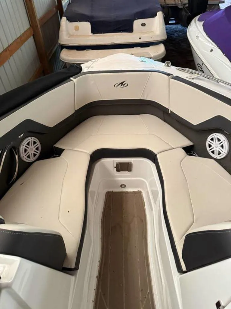 Slide: The Image of 2016 Sea Ray SLX 250 boat interior with cushioned seating and speakers. - 13