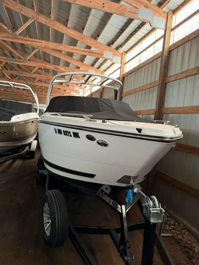 Slide: The Image of 2016 Sea Ray SLX 250 boat stored indoors on a trailer. - 5