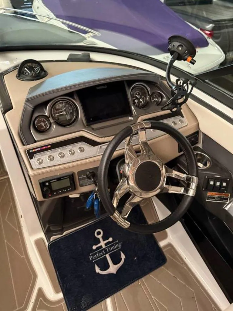 Slide: The Image of 2016 Sea Ray SLX 250 boat dashboard with steering wheel and control panel. - 9