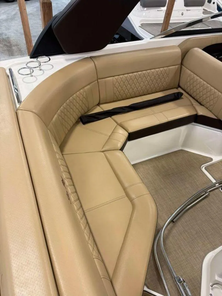 Slide: The Image of 2019 Sea Ray SLX 230 boat interior with tan leather seating and cup holders. - 3
