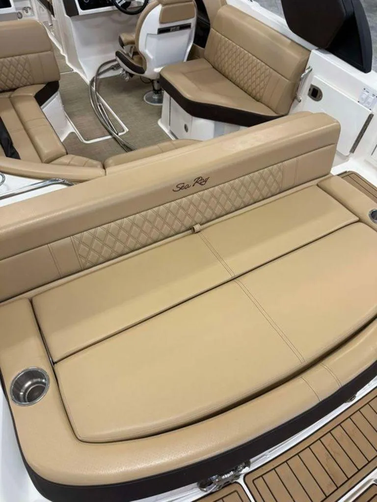 Slide: The Image of 2019 Sea Ray SLX 230 boat interior with tan leather seating and cup holders. - 6