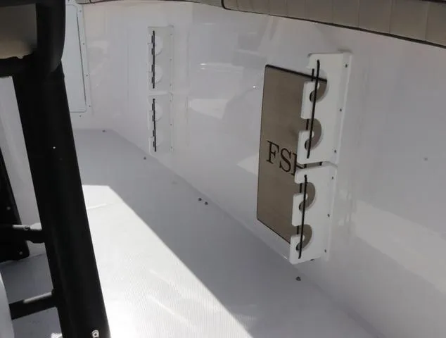 Slide: The Image of 2025 Yamaha Boats 255 FSH SPORT H-SEAFOAM G interior with tan seating and deck. - 12