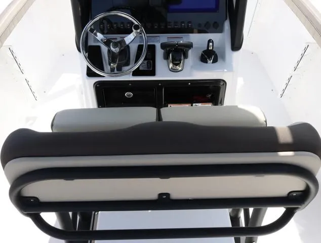 Slide: The Image of 2025 Yamaha Boats 255 FSH SPORT H-SEAFOAM G interior with beige seating and wood accents. - 14