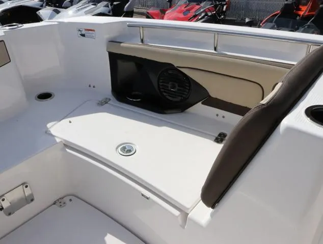 Slide: The Image of 2025 Yamaha Boats 255 FSH SPORT H-SEAFOAM G interior seating with speaker and storage. - 20