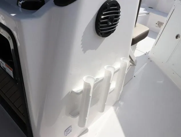 Slide: The Image of 2025 Yamaha Boats 255 FSH SPORT H-SEAFOAM G interior with rod holders and speaker. - 23