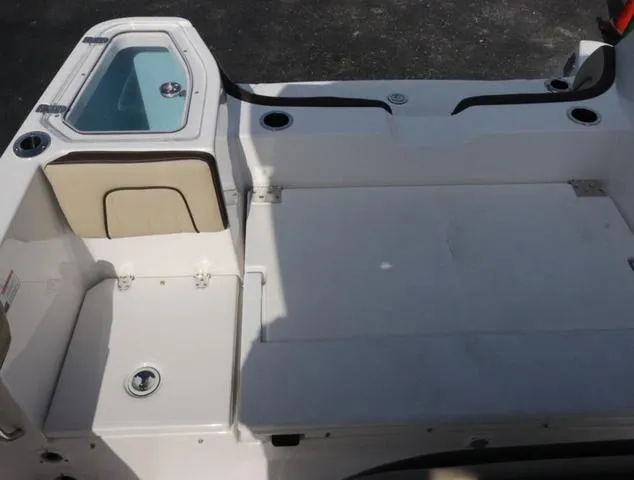 Slide: The Image of 2025 Yamaha Boats 255 FSH SPORT H-SEAFOAM G interior, featuring seating and storage compartments. - 24