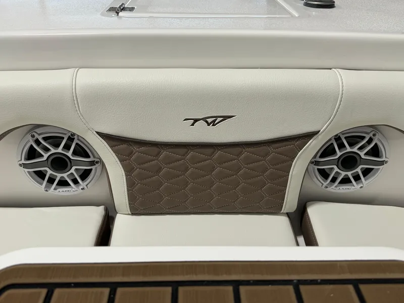 Slide: The Image of 2024 Tidewater 272 CC Adventure boat interior with speakers and quilted upholstery. - 10