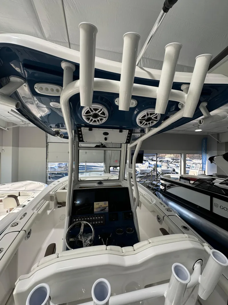 Slide: The Image of 2024 Tidewater 272 CC Adventure boat interior with rod holders and control panel. - 11