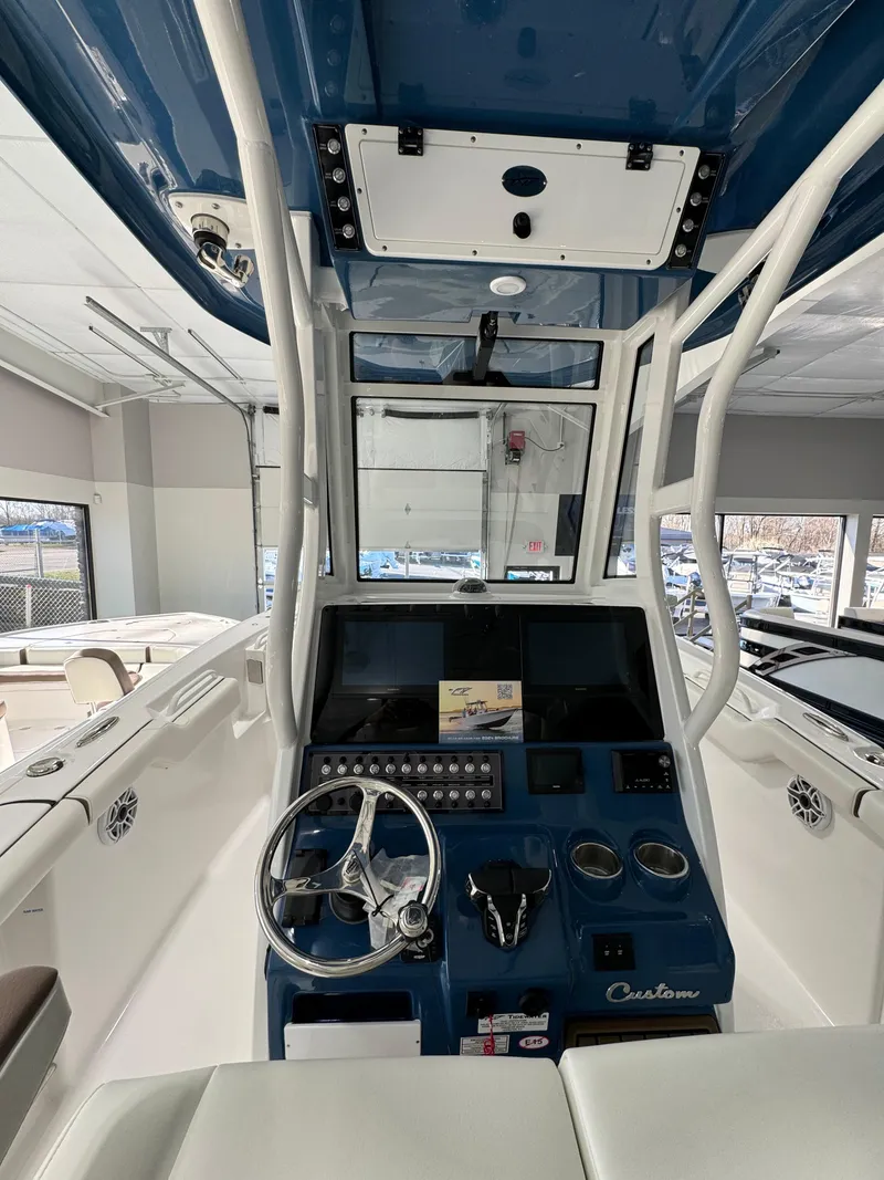 Slide: The Image of 2024 Tidewater 272 CC Adventure boat cockpit with modern controls and steering wheel. - 12