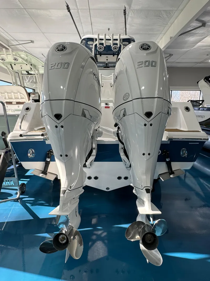 Slide: The Image of 2024 Tidewater 272 CC Adventure boat with dual 200 horsepower engines in showroom. - 3