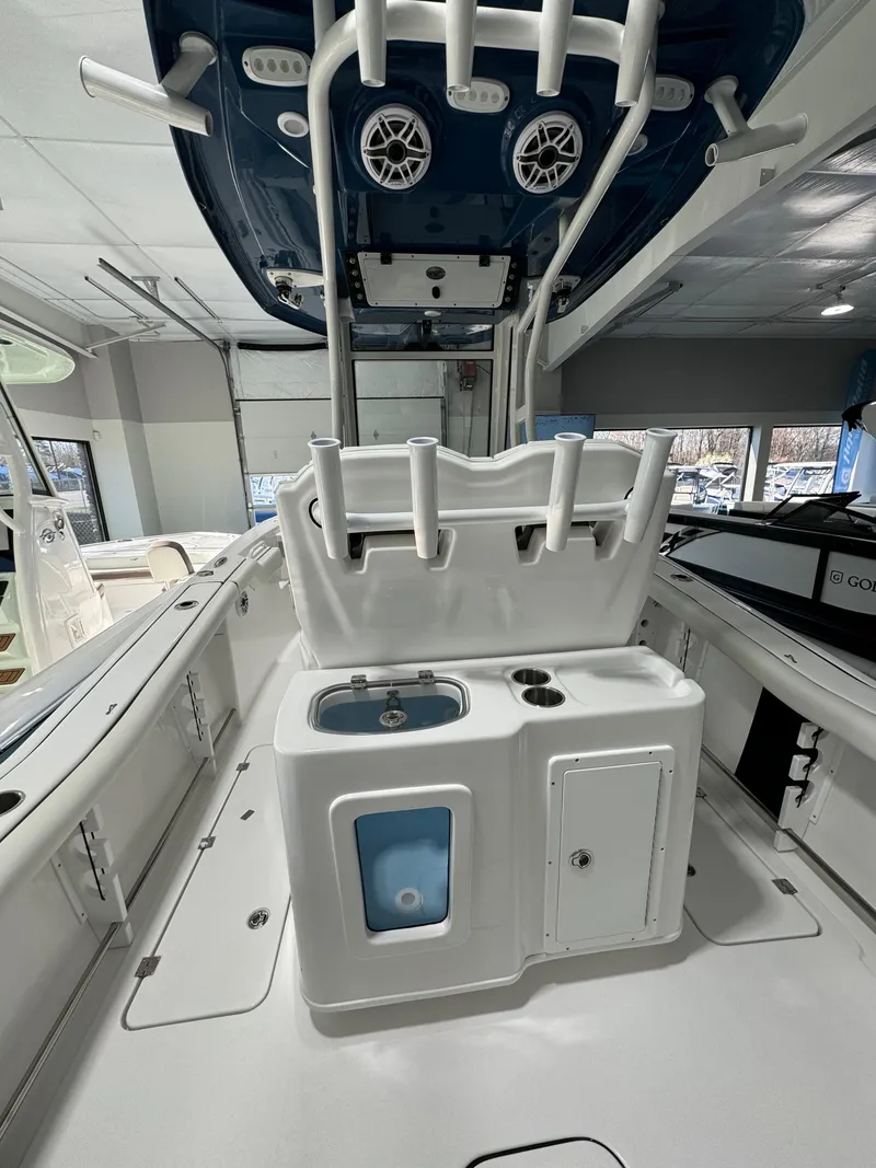 Slide: The Image of 2024 Tidewater 272 CC Adventure boat interior with fishing rod holders and storage compartments. - 4