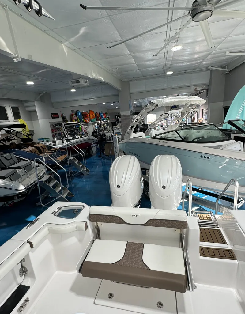 Slide: The Image of 2024 Tidewater 272 CC Adventure boat in showroom with dual engines. - 6