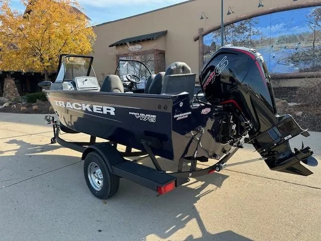 Slide: The Image of 2025 Tracker Pro Guide V-175 Combo boat on trailer, outdoor setting. - 2