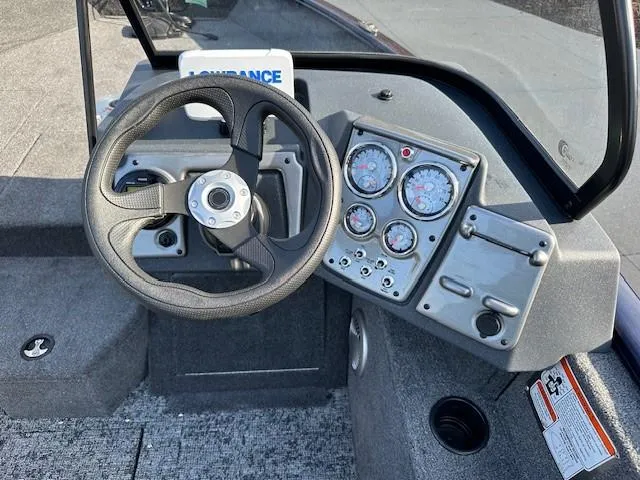 Slide: The Image of 2025 Tracker Pro Guide V-175 Combo boat dashboard with steering wheel and gauges. - 5