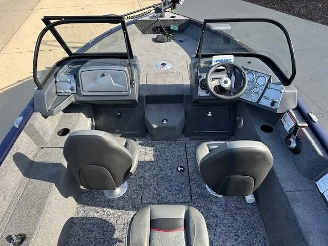Slide: The Image of 2025 Tracker Pro Guide V-175 Combo boat interior with steering console and seating. - 7