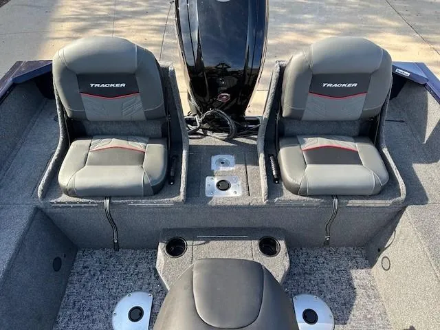 Slide: The Image of 2025 Tracker Pro Guide V-175 Combo boat interior with dual seats and motor. - 9