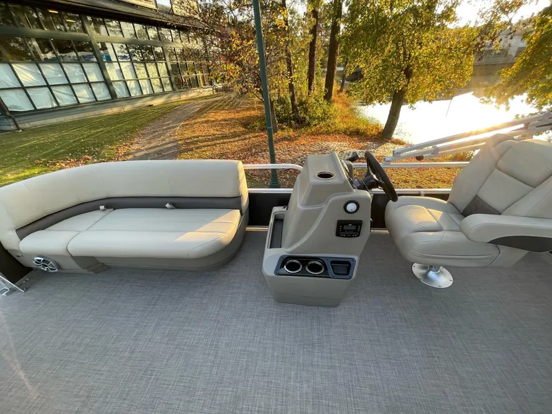 Slide: The Image of 2025 Sun Tracker Party Barge 16 DLX interior with seating and steering console. - 43