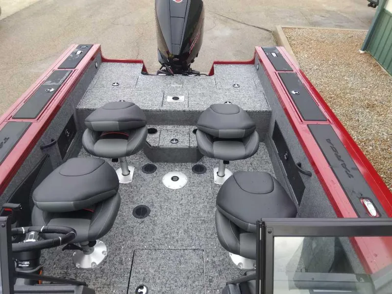 Slide: The Image of 2025 Tracker Targa V-18 WT boat interior with four seats and motor. - 2