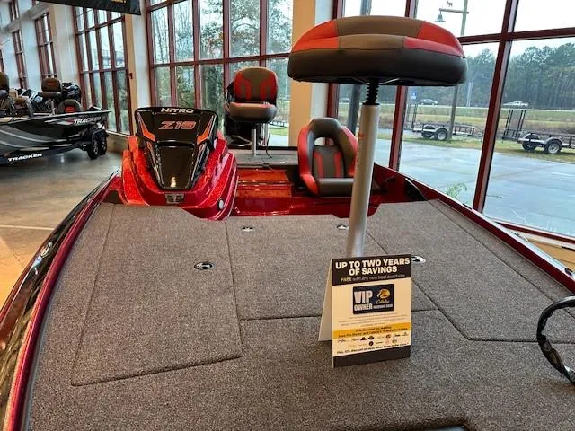 Slide: The Image of 2025 Nitro Z19 boat interior with seating and promotional sign in showroom. - 2