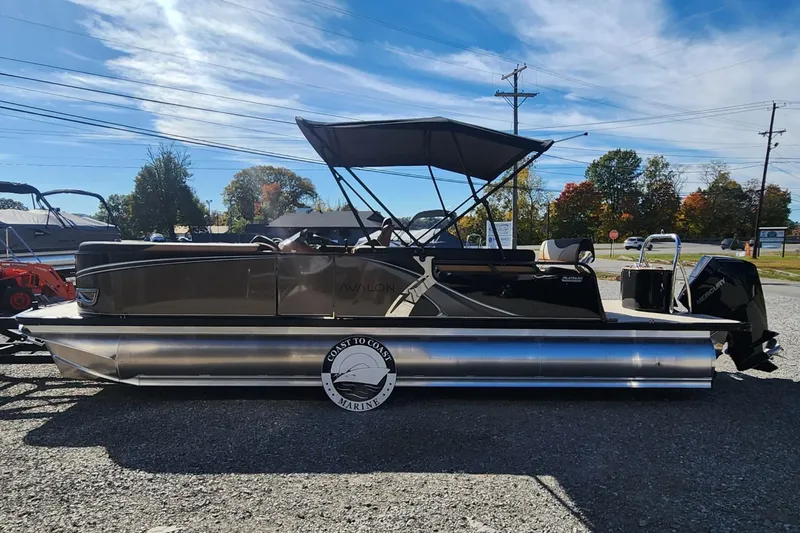 Slide: The Image of 2025 Avalon Platinum LSZ 2385 Cruise Rear Bench pontoon boat in outdoor setting. - 1