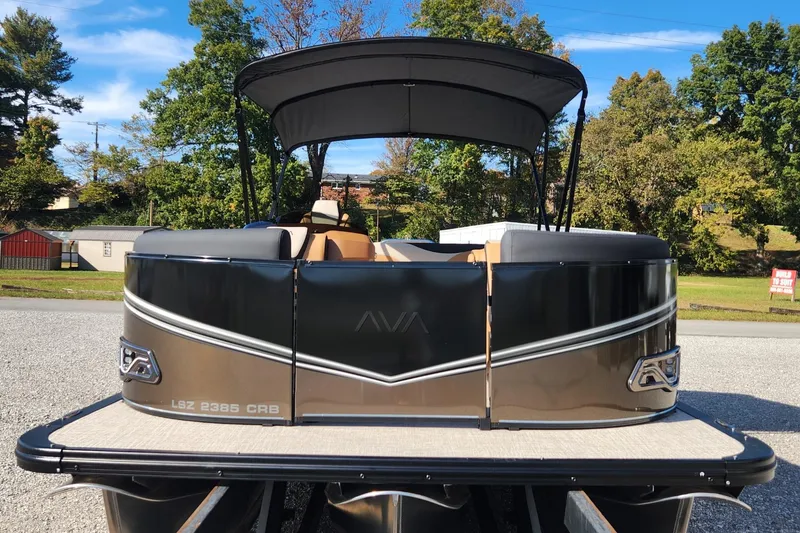 Slide: The Image of 2025 Avalon Platinum LSZ 2385 Cruise Rear Bench pontoon boat, parked outdoors. - 2
