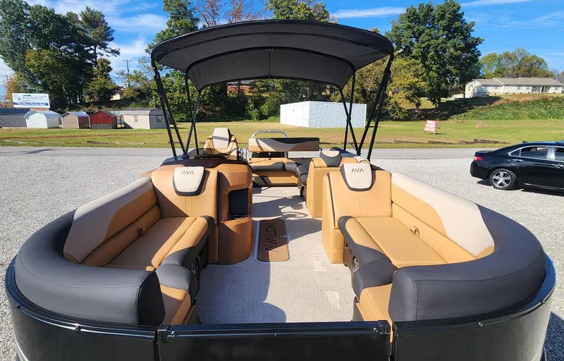 Slide: The Image of 2025 Avalon Platinum LSZ 2385 Cruise Rear Bench pontoon boat with tan seating and canopy. - 4