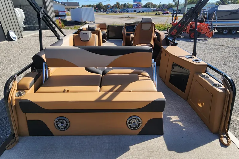 Slide: The Image of 2025 Avalon Platinum LSZ 2385 Cruise Rear Bench boat interior with tan seating and modern amenities. - 9