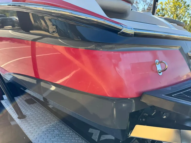 Slide: The Image of 2014 MasterCraft X46 boat, red and black exterior, close-up view. - 11