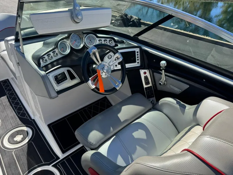 Slide: The Image of 2014 MasterCraft X46 boat interior with steering wheel and dashboard controls. - 18