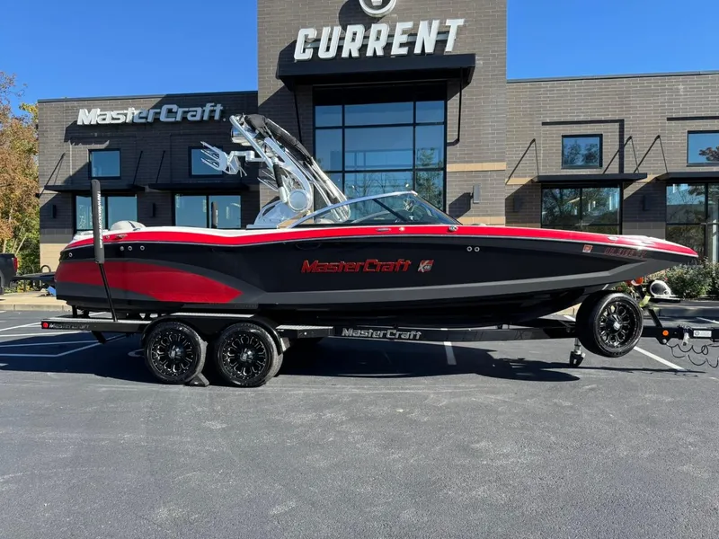 Slide: The Image of 2014 MasterCraft X46 boat on trailer in front of dealership. - 3