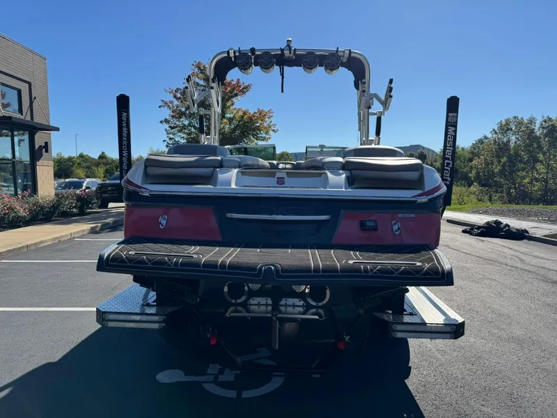 Slide: The Image of 2014 MasterCraft X46 boat parked in a sunny lot, rear view. - 5