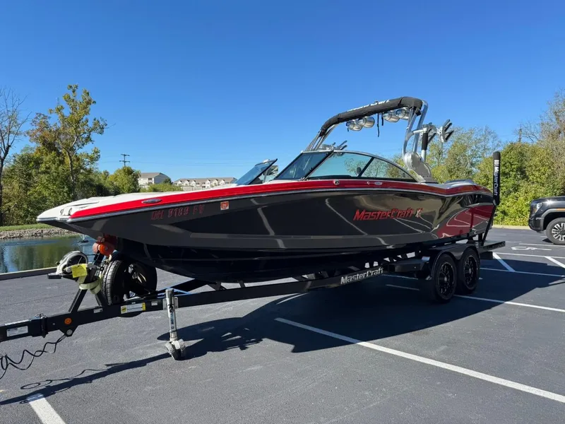 Slide: The Image of 2014 MasterCraft X46 boat on trailer in parking lot, sunny day. - 8