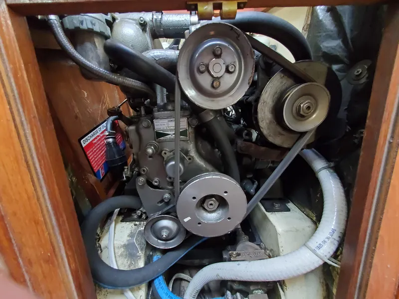 Slide: The Image of Engine compartment of a 1987 Pearson 31-2 sailboat, showing belts and hoses. - 10