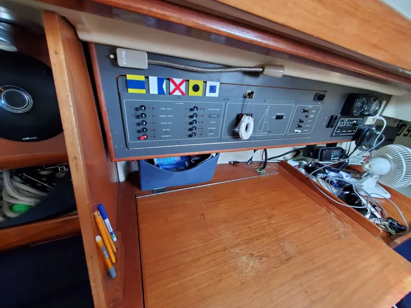 Slide: The Image of 1987 Pearson 31-2 sailboat navigation panel with nautical flags and equipment. - 12