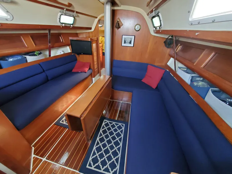 Slide: The Image of Interior of 1987 Pearson 31-2 sailboat with blue seating and wooden accents. - 18