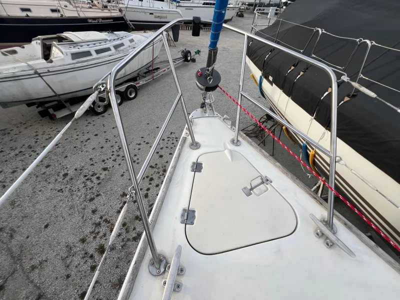 Slide: The Image of Pearson 31-2 sailboat deck, 1987 model, in a boatyard with other vessels. - 27