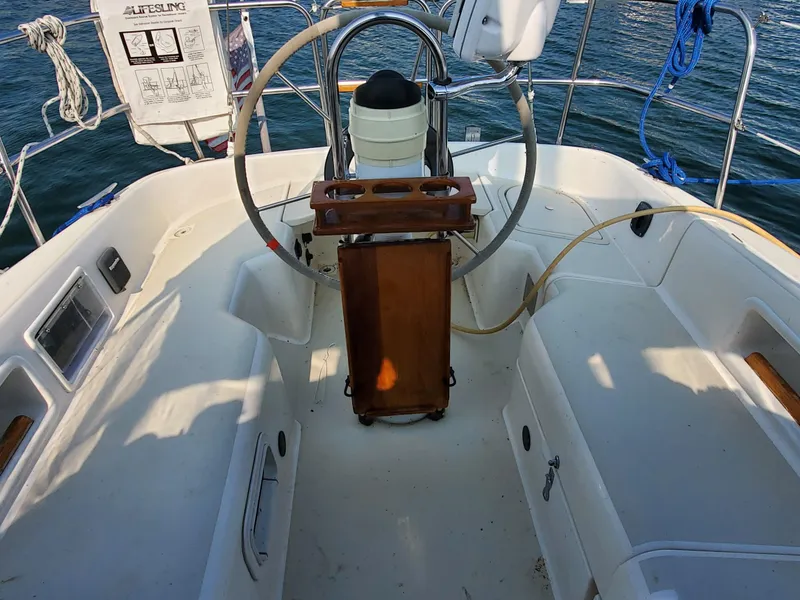 Slide: The Image of Cockpit of a 1987 Pearson 31-2 sailboat with steering wheel and navigation equipment. - 5