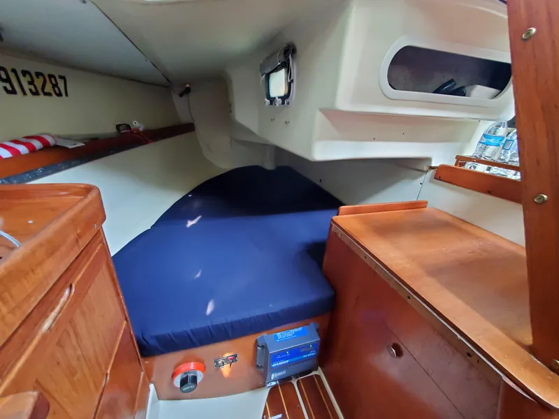 Slide: The Image of Cozy cabin interior of a 1987 Pearson 31-2 sailboat with wooden furnishings. - 8